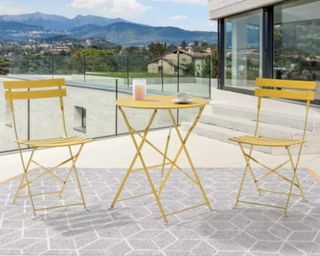 Sonkuki 3-Piece Steel All-weather Outdoor Bistro Set yellow metal on terrace