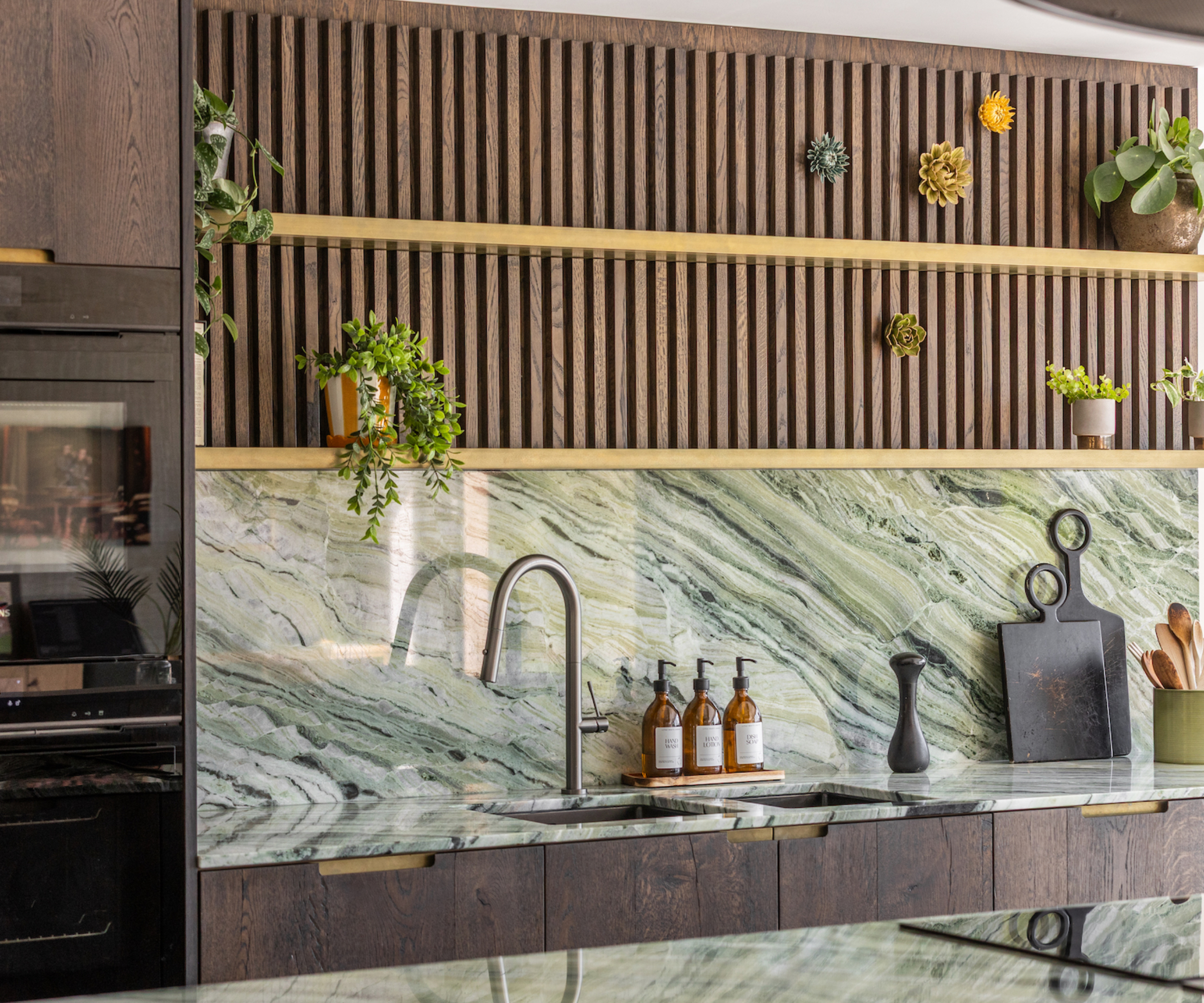 kitchen with dark wood cabinets and marbled sage green inspired splashback