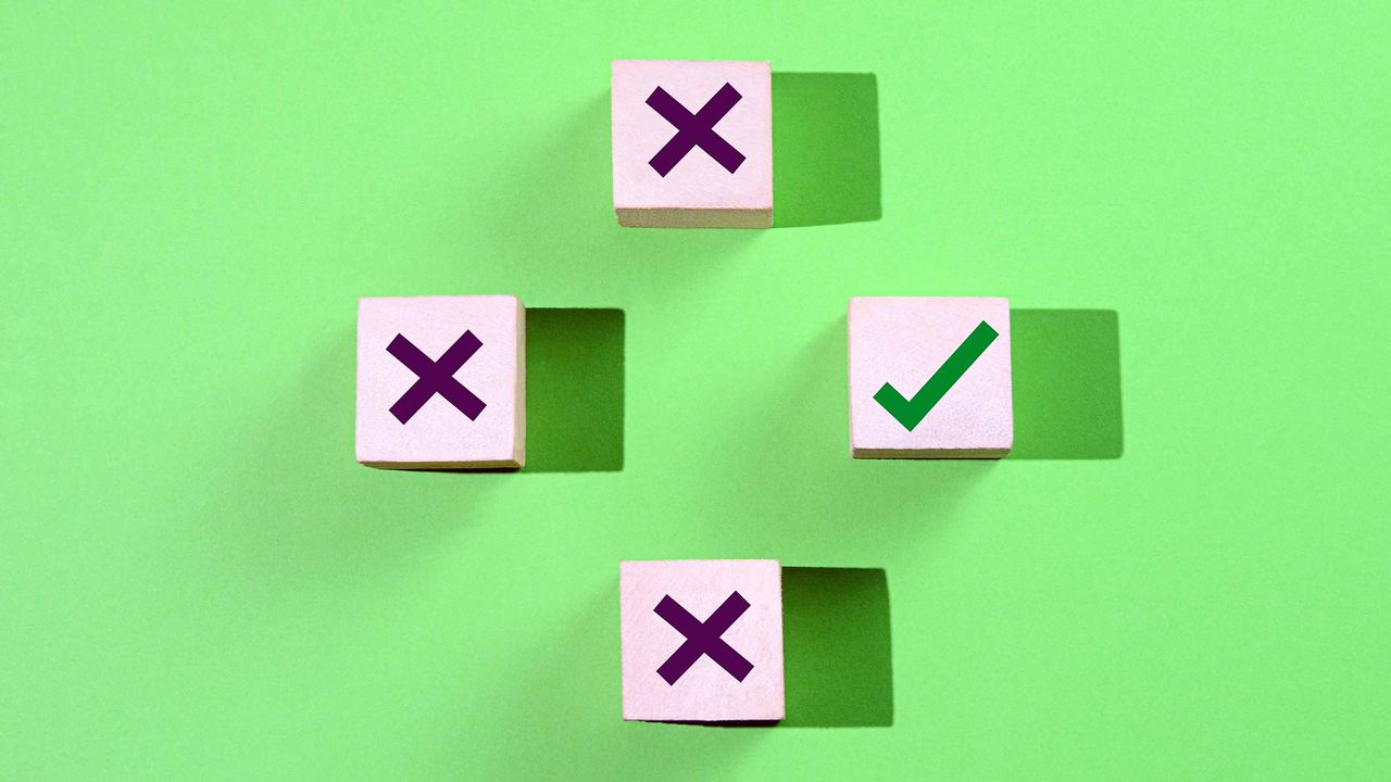 three wooden blocks with x&#039;s and one with a checkmark