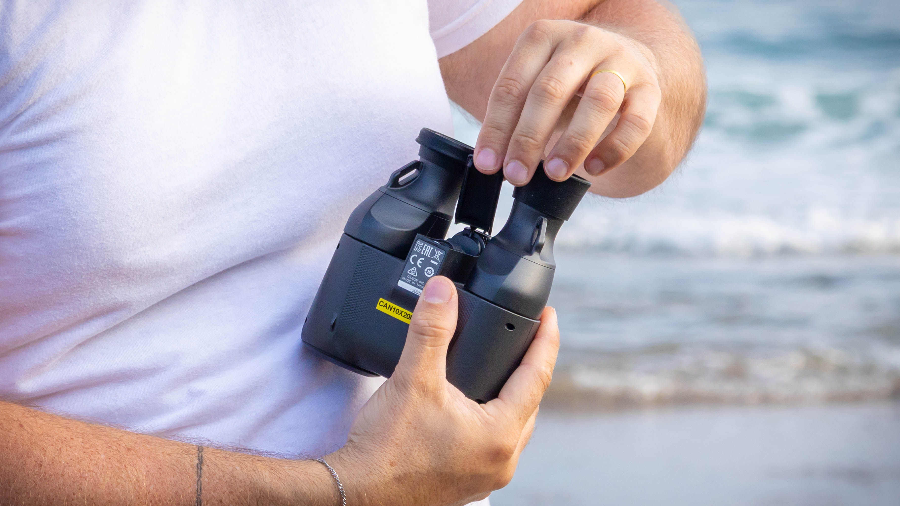 The open battery compartment of the Canon 10x20 IS binoculars.