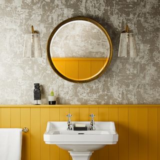 Yellow and grey bathroom with wall lights