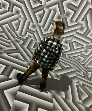 A child jumping into an interactive, immersive experience provided by Christie projectors.