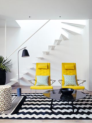 Black and white living room with contemporary yellow armchairs