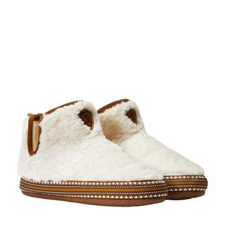 A pair of cream coloured sherpa-like slipper booties with brown suede soles.
