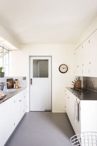 Kitchen view of white cupboards and counters