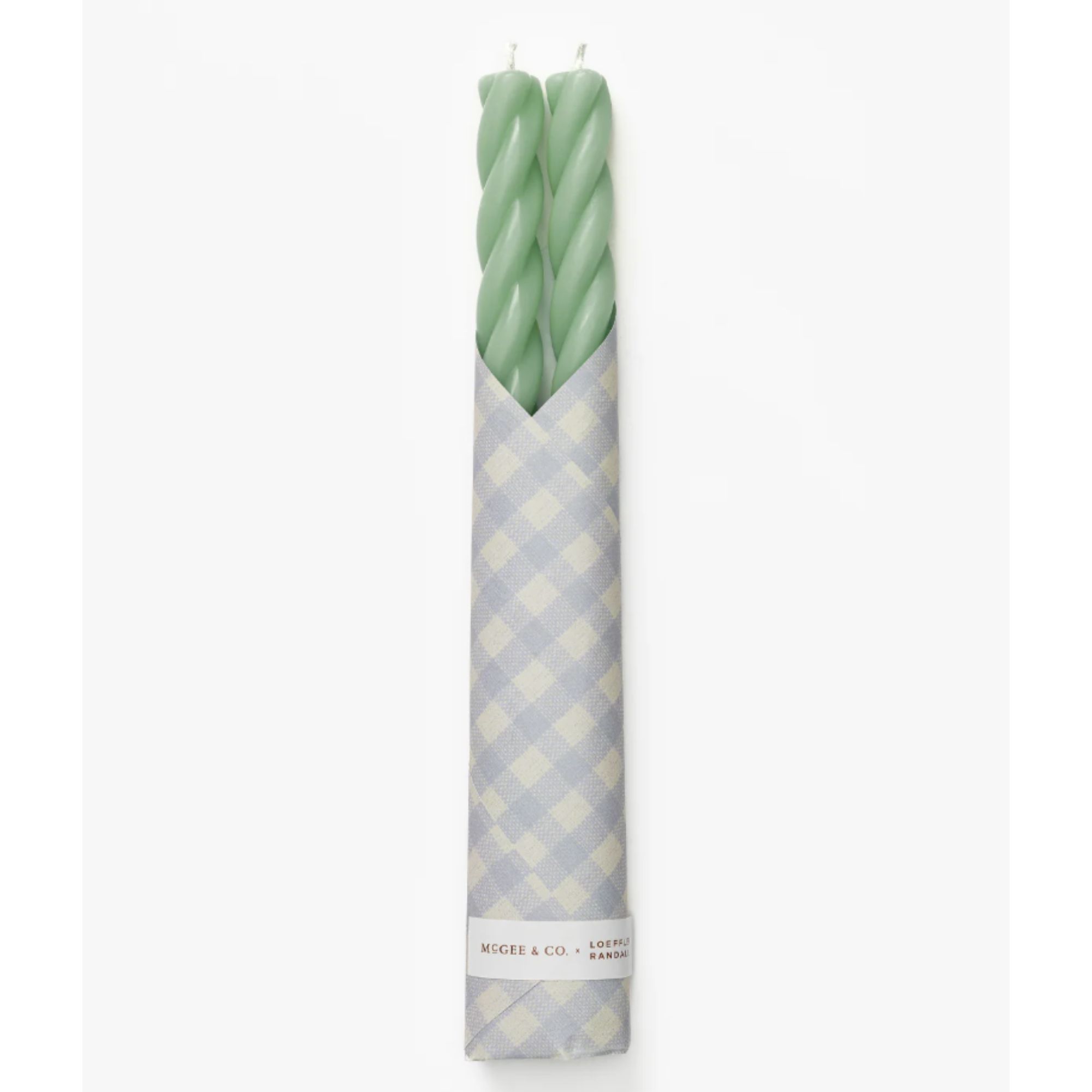 Green twist taper candles wrapped in gingham paper