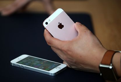 A person holds an iPhone.