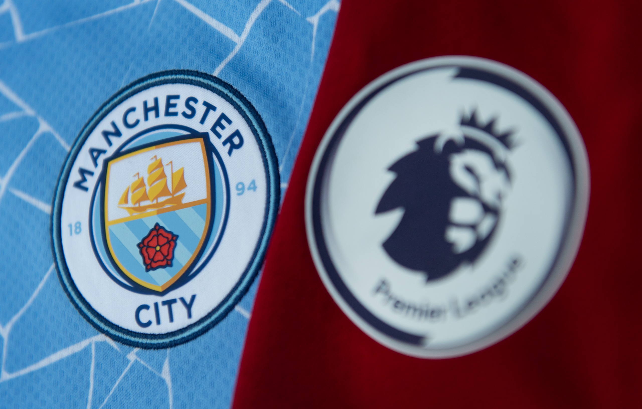 Manchester City badge alongside the Premier League logo