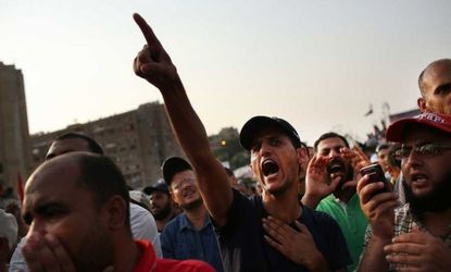 Mohamed Morsi supporters rally near the place where over 50 were purported to have been killed by members of the Egyptian military and police in early morning clashes on July 8 in Cairo.