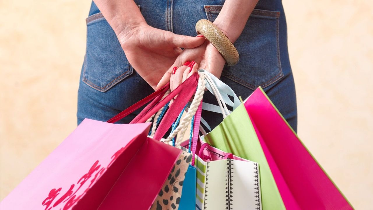 Memorial Day sales: woman holding multi-colored shopping bags from various stores