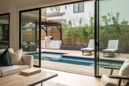 a small backyard with a pool and bamboo growing