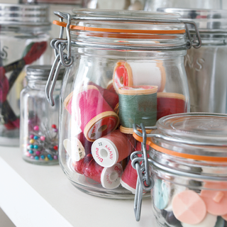 craft room with jam jars pins beads and cotton reels