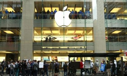 Customers line up outside an Apple store in Sydney Australia on Sept. 21.
