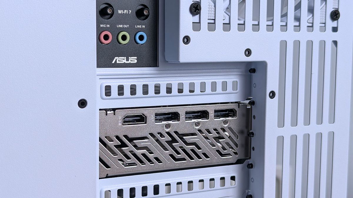 Close-up of an iBUYPOWER RDY Trace X R01 computer's rear panel showing an Asus logo, Wi-Fi 7 module, colored audio ports, and multiple HDMI outputs.