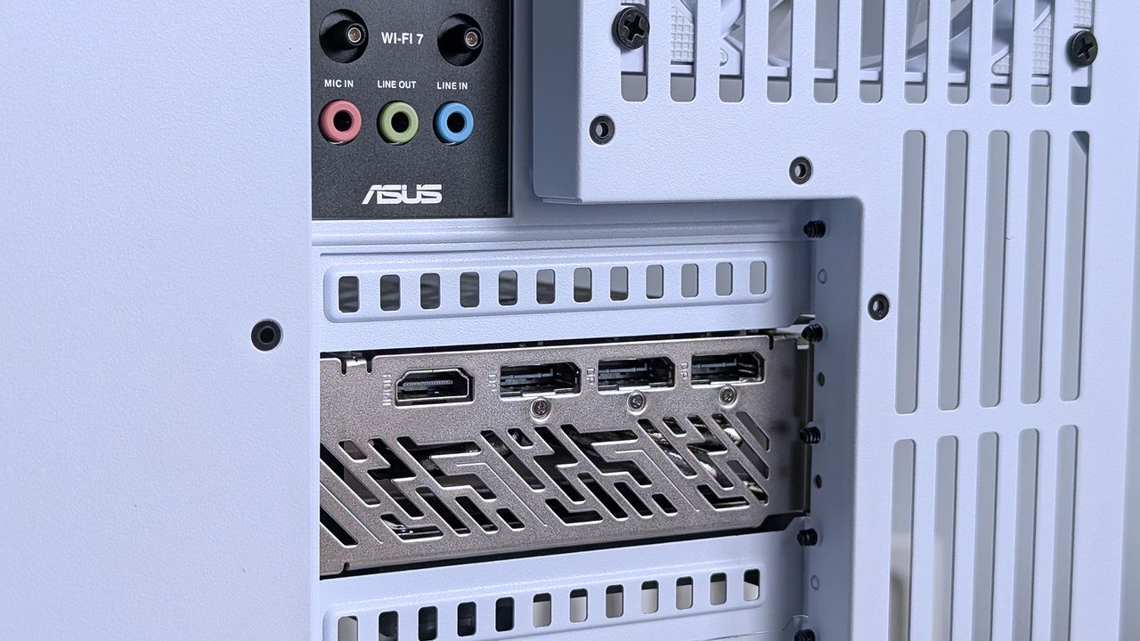 Close-up of an iBUYPOWER RDY Trace X R01 computer's rear panel showing an Asus logo, Wi-Fi 7 module, colored audio ports, and multiple HDMI outputs.