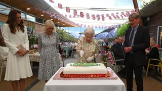 watched over by britain's catherine, duchess of cambridge l, britain's camilla, duchess of cornwall 2nd l and board director of eden project, peter stewart r, britain's queen elizabeth ii c eventually cuts a cake with a knife, to celebrate of the big lunch initiative at the eden project, near st austell in south west england on june 11, 2021 photo by oli scarff pool afp photo by oli scarffpoolafp via getty images