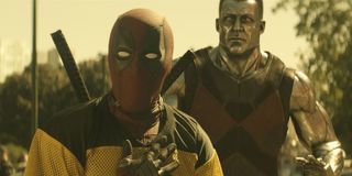 Deadpool with his hand on his heart, standing in front of Colossus, in Deadpool 2.