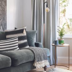 Living room with grey sofa and side table