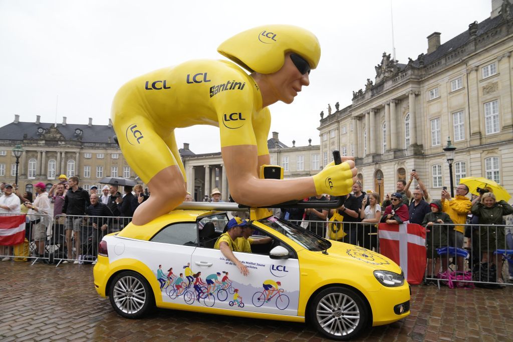 Spectators look on as a promotion car decorated by advertisers takes part in the caravan in Copenhagen on July 1 2022 prior to the individual time trial first stage of 2022 edition of the Tour de France cycling race Denmark OUT Photo by Mads Claus Rasmussen Ritzau Scanpix AFP Denmark OUT Photo by MADS CLAUS RASMUSSENRitzau ScanpixAFP via Getty Images