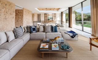 Main open living space with large corner couch, coffee table and large windows at Sabina Estates Villa