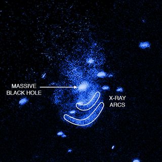 An annotated view of the "burping" supermassive black hole in the galaxy Messier 51 as seen in X-rays by NASA's Chandra X-ray Observatory in the galaxy Messier 51.