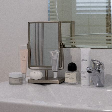 Bathroom sink with beauty products 