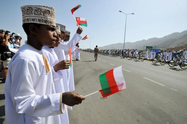 Specactors in Oman cheer on the passing peloton