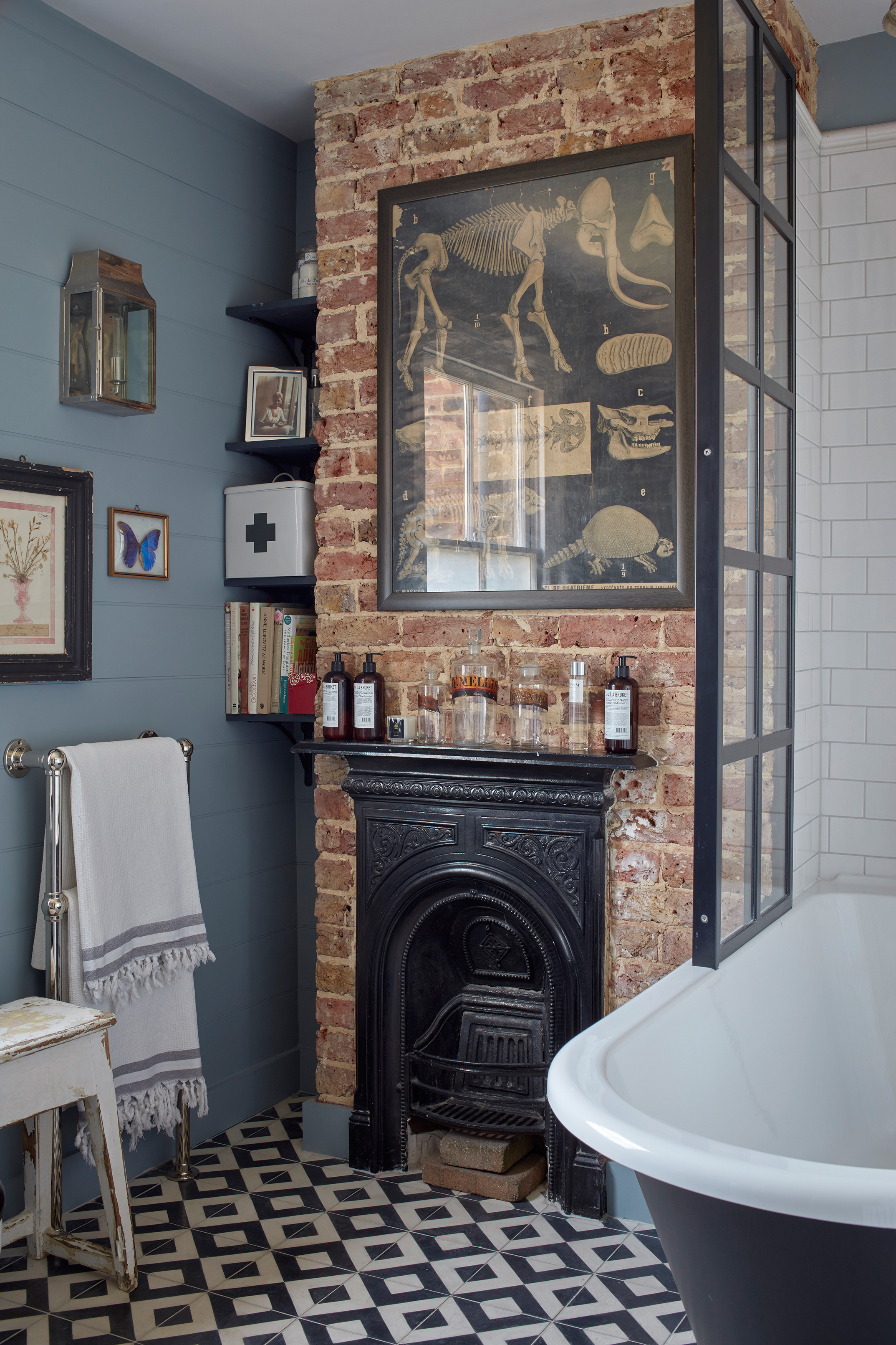 brick fireplace with fire in bathroom