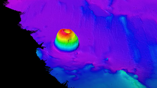 A multibeam sonar image shows the newly discovered undersea mountain with a crater that looks like a Bundt cake.