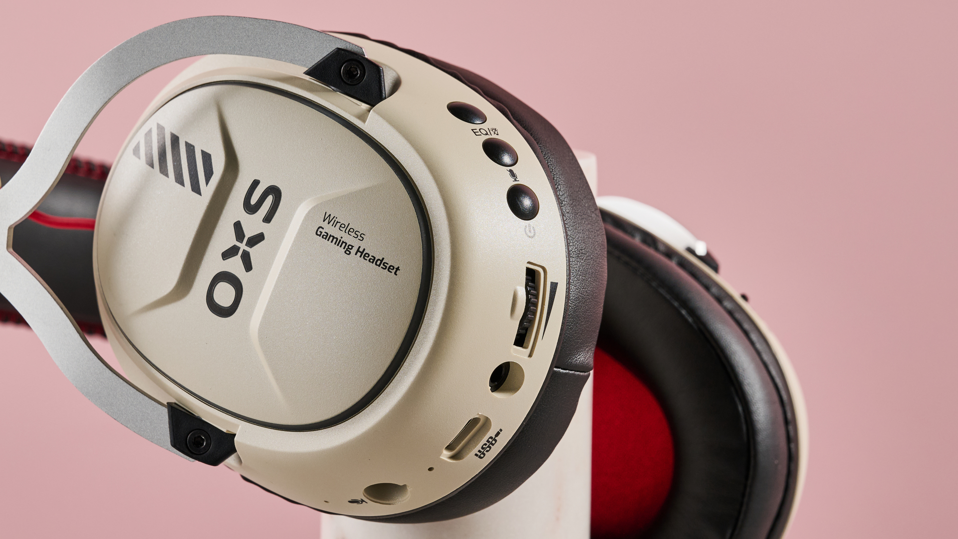 Close-up of buttons and ports on OXS Storm G2, leaning on plinth with pink background