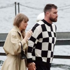 Taylor Swift and Travis Kelce in Lake Como where Taylor Swift wears a trench coat and carries a black Versace bag to match her black dress