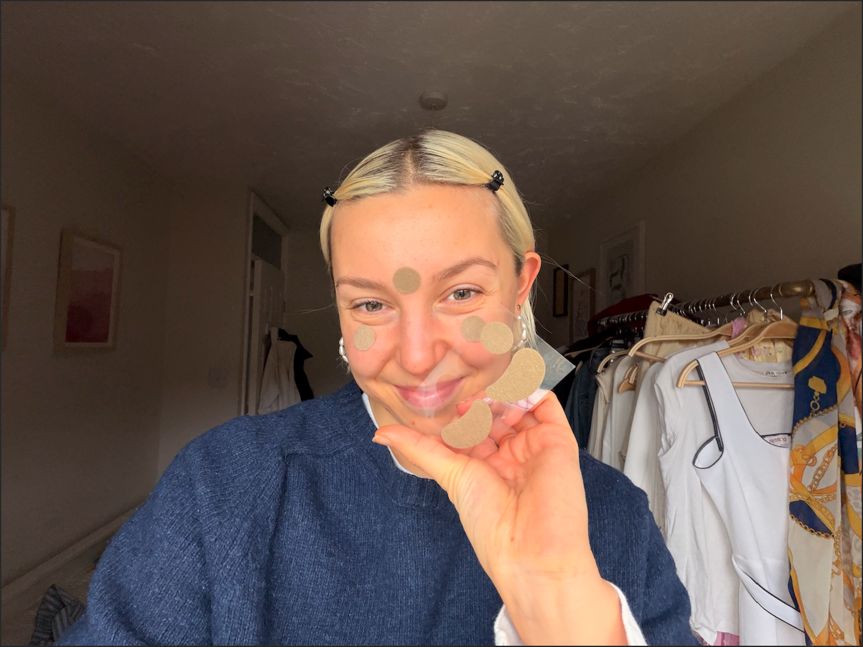 A woman wearing facial acupressure patches