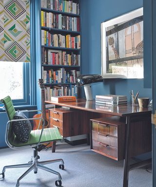Blue home office with large wooden desk