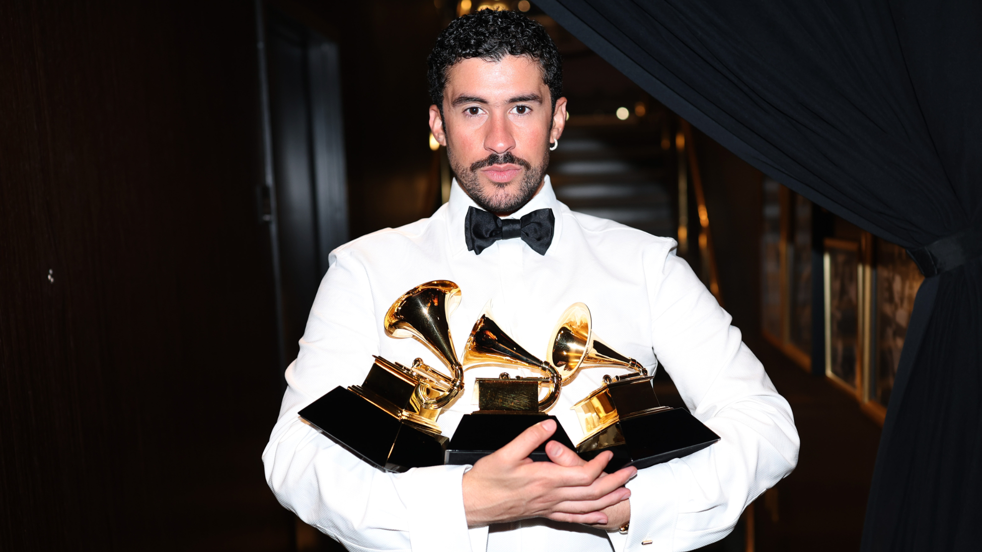 Bad Bunny poses with the Album of the Year, Best M&uacute;sica Urbana Album, and Best Global Music Performance Awards during the 68th GRAMMY Awards