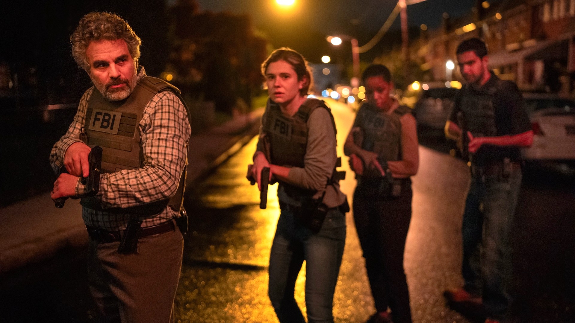 L-R: Mark Ruffalo and Alison Oliver wearing bulletproof vests in a scene from HBO's "Task"