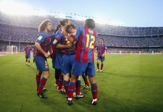 Lionel Messi celebrates with his team-mates after scoring his first Barcelona goal in 2005 against Albacete.