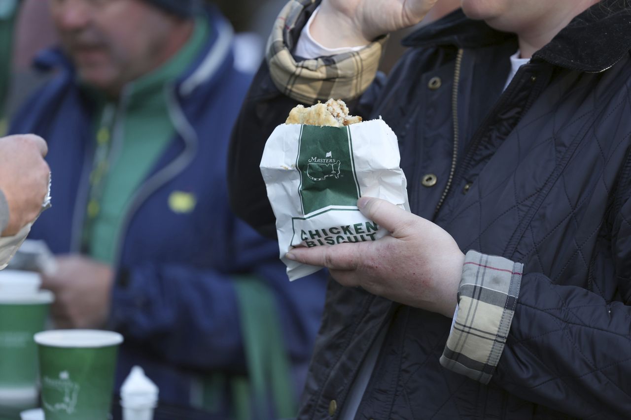 A patron eating a chicken biscuit at the 2022 Masters Tournament