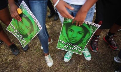 People stand together on Feb. 9 in honor of Trayvon Martin during a "March for Peace" in Miami.