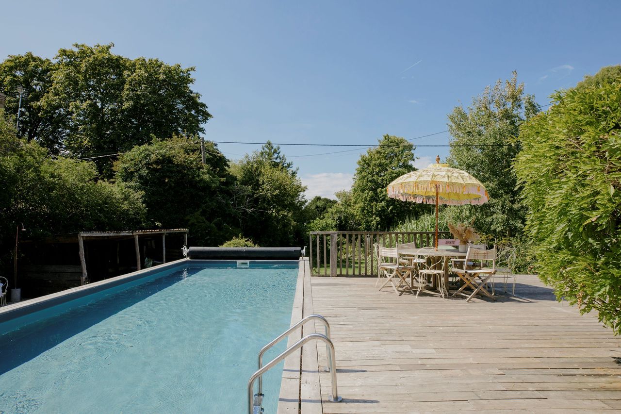 The pool has wooden decking around it