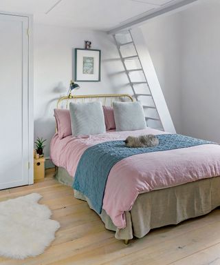 bedroom with wooden floor and white wall and ladder