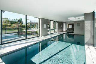 large swimming pool with sliding glass doors
