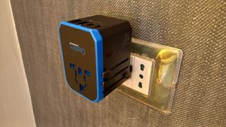Ceptics 70W World Travel Plug Adapter plugged into socket