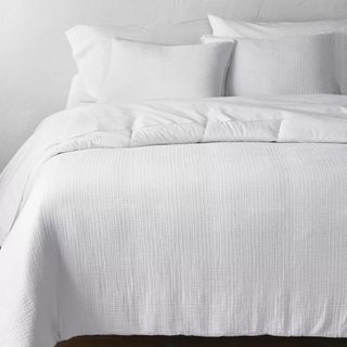 Textured Chambray Cotton Comforter & Sham Set against a white wall.