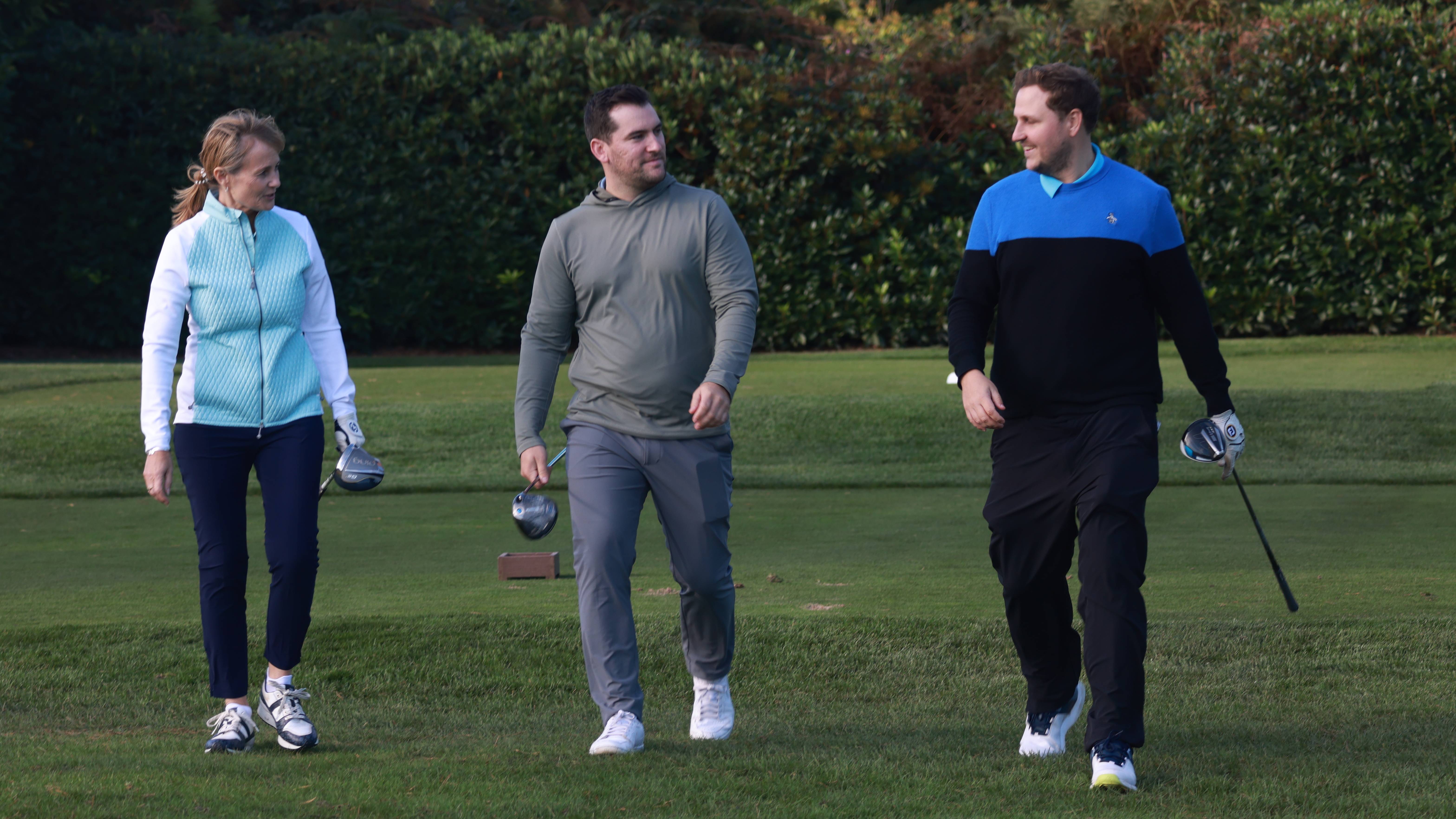 Three golfers chatting after leaving the tee