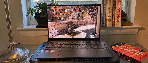 An Asus Zenbook S 13 OLED on a laptop stand