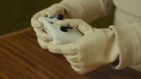 A robot holding an Xbox controller