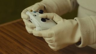 A robot holding an Xbox controller