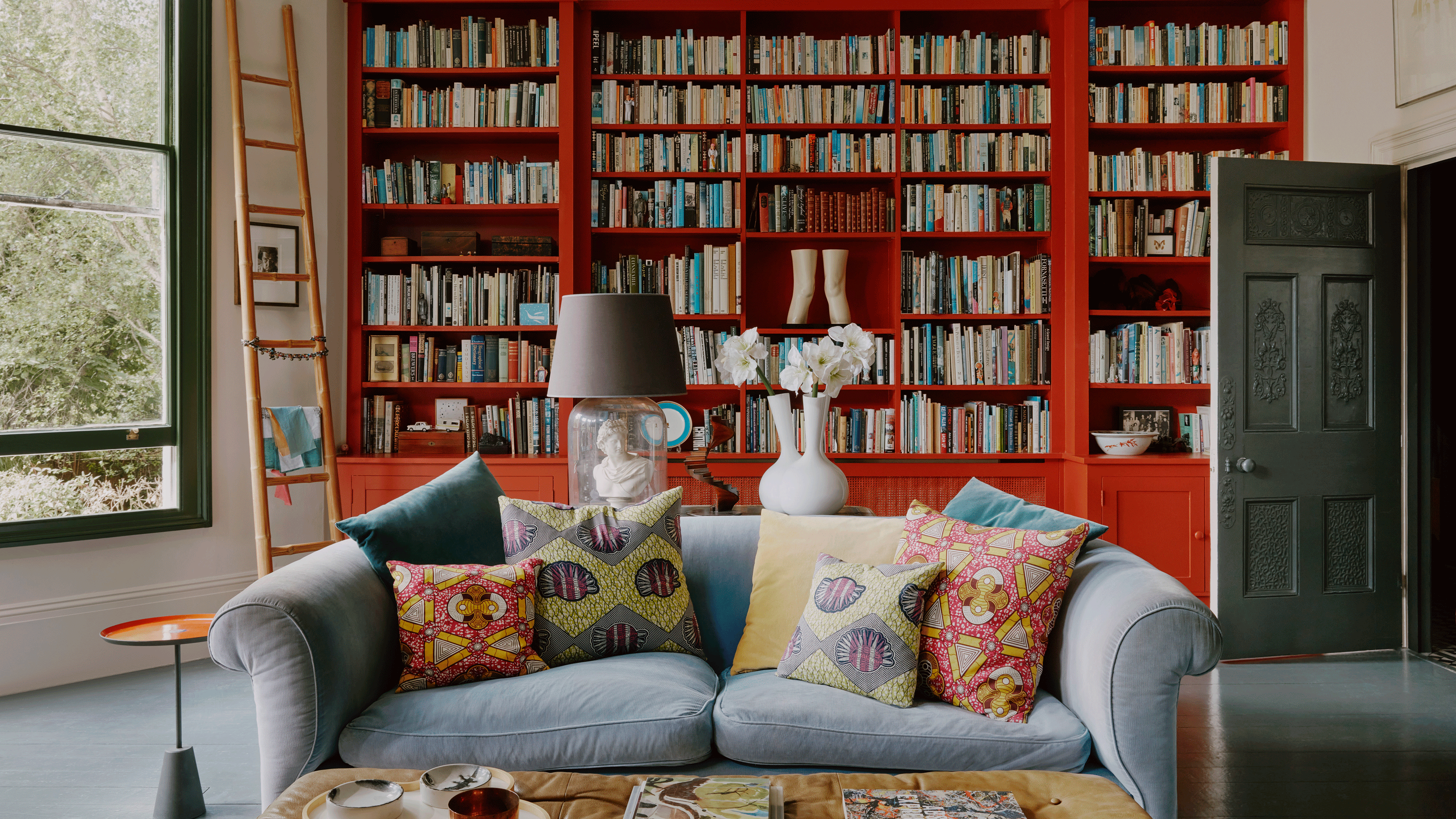 Living room with window seat surrounded by houseplants