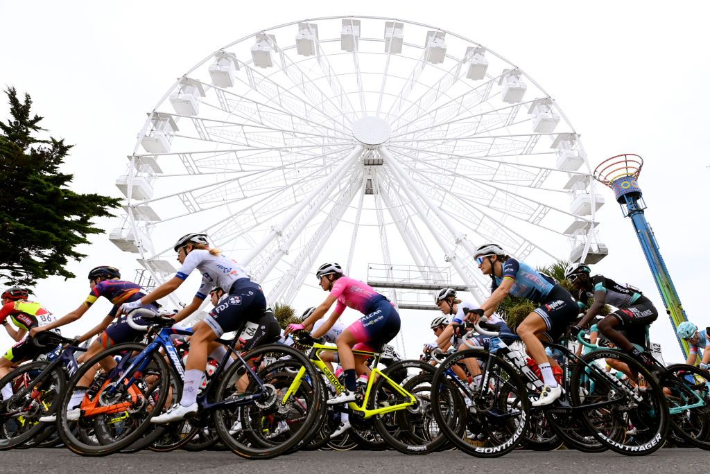 CLACTONONSEA ENGLAND OCTOBER 08 A general view of Victorie Guilman of France and Team FDJ Nouvelle Aquitaine Futuroscope Margaux Vigie of France and Team Valcar Travel Service Elisabeth DeignanArmitstead of United Kingdom and Team Trek Segafredo and Teniel Campbell of Trinidad and Tobago and Team BikeExchange and the peloton compete through Clacton on Sea city with the image of a ferris wheel in the background during the 7th The Womens Tour 202 Stage 5 a 954km stage from Colchester to Clacton thewomenstour UCIWWT on October 08 2021 in ClactononSea England Photo by Justin SetterfieldGetty Images