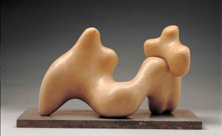 Sculpture formed of two caramel-coloured irregular 3D shapes. The smaller shape sits on top of the larger one.